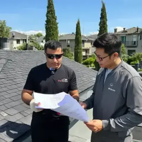 Roof Express team reviewing quote on rooftop